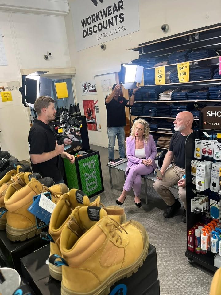 Amanda directing a commercial shoot on location in a workwear store